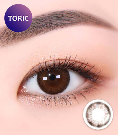 Close-up of eye with Aida Choco Brown toric contact lens, showing chocolate color and delicate iris design for natural look.
